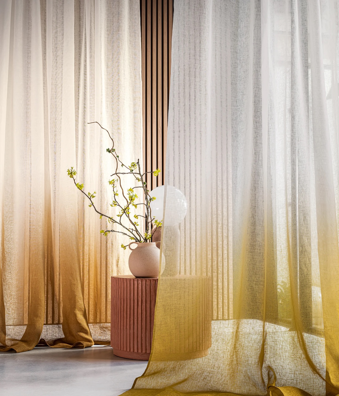 Sheer curtains with armchair and floor lamp